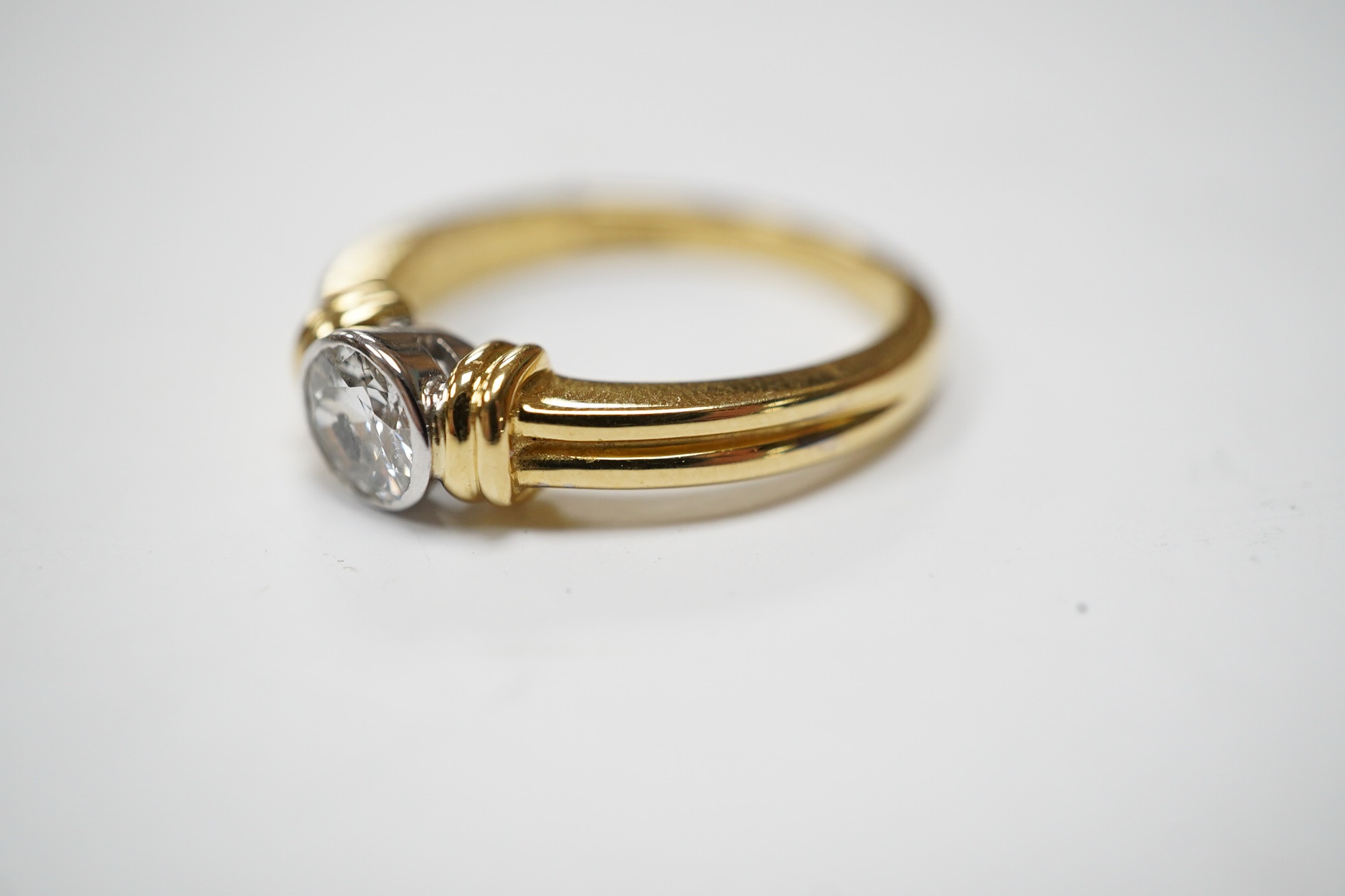 A modern 18ct gold and collet set solitaire diamond ring, size O, gross weight 5.7 grams. Condition - fair to good.